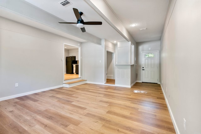 empty room with light hardwood / wood-style flooring and ceiling fan