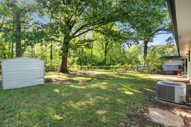 view of yard featuring a storage shed and central AC unit