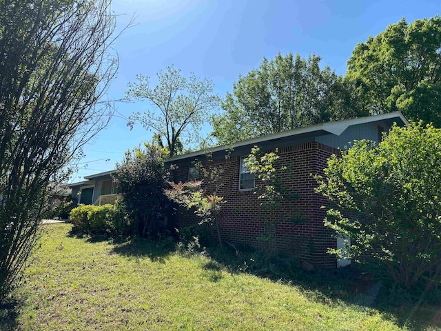 view of home's exterior with a lawn