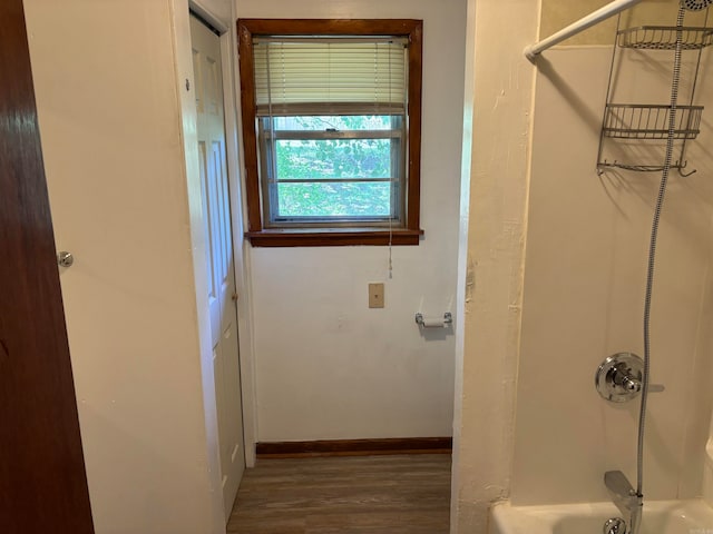 bathroom featuring bathtub / shower combination and hardwood / wood-style flooring