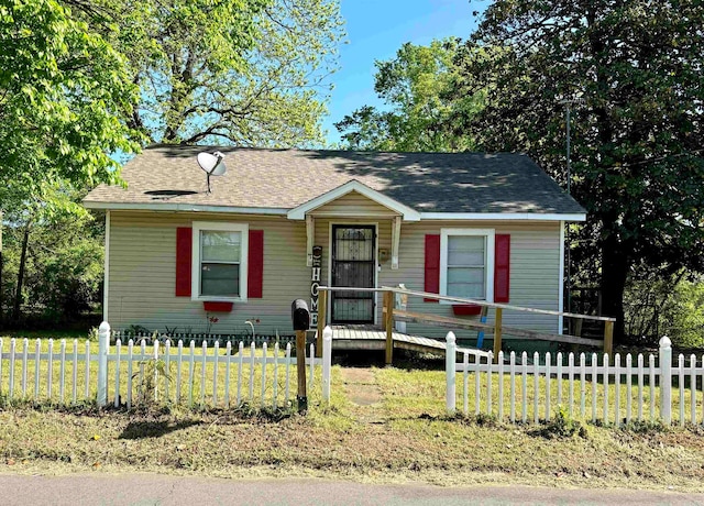 view of front of property featuring a deck and a front lawn