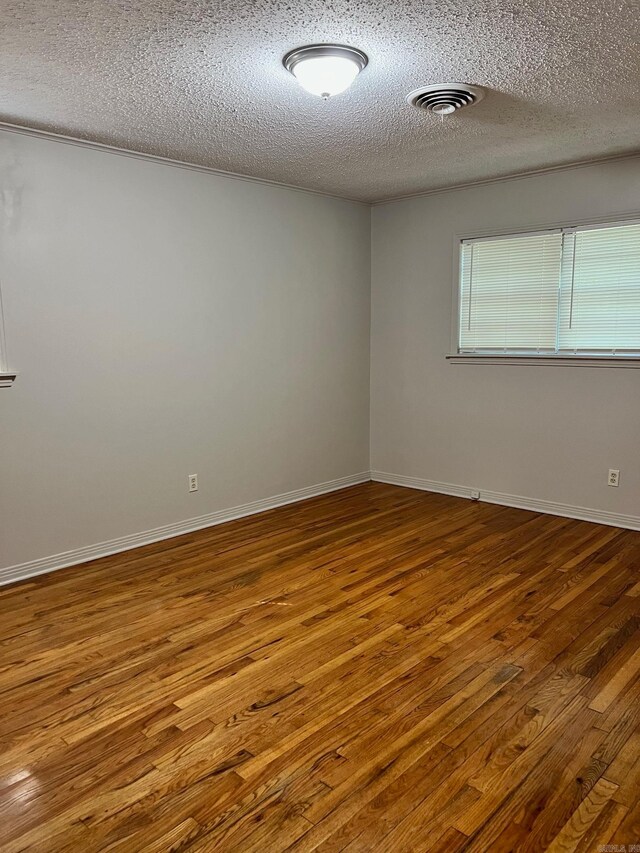 unfurnished room with dark hardwood / wood-style floors and a textured ceiling