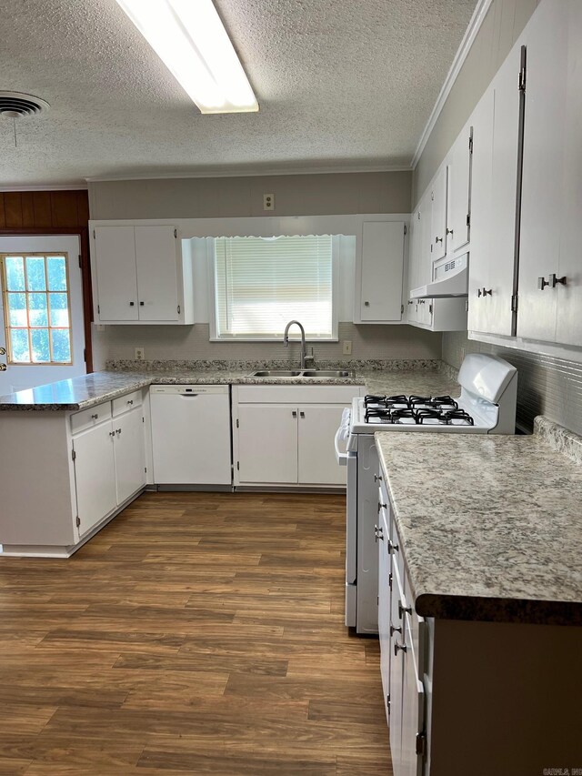 kitchen featuring white appliances, crown molding, white cabinetry, hardwood / wood-style floors, and sink