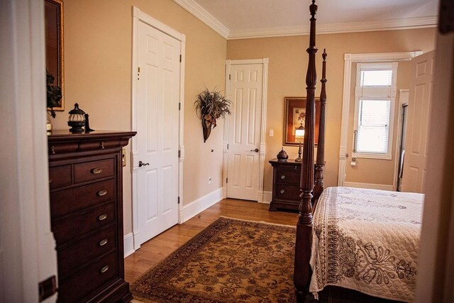 bedroom featuring hardwood / wood-style flooring and crown molding