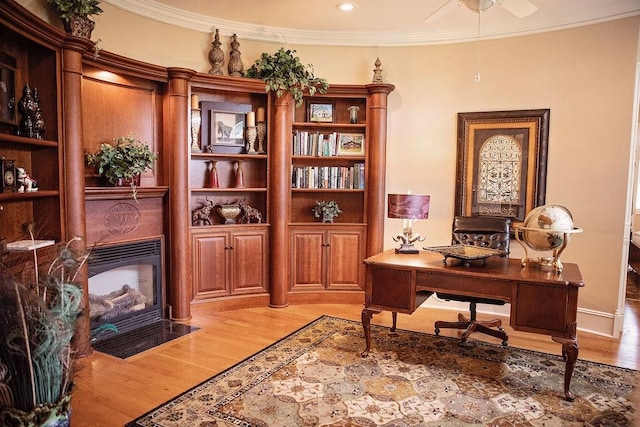 office space with crown molding, wood-type flooring, and ceiling fan