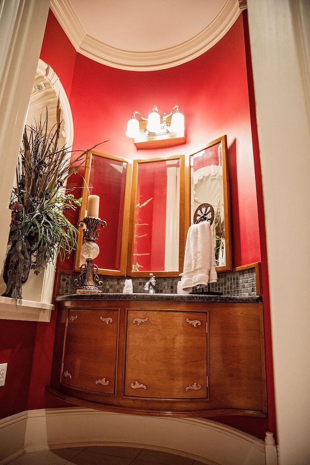 bathroom featuring backsplash, vanity, and crown molding