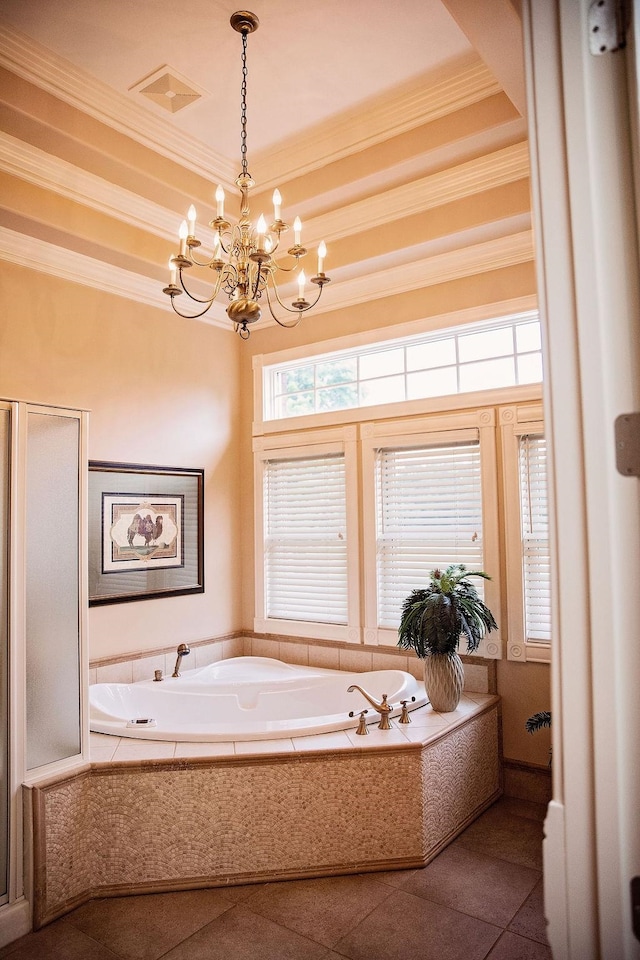 bathroom featuring an inviting chandelier, tiled tub, a tray ceiling, crown molding, and tile flooring