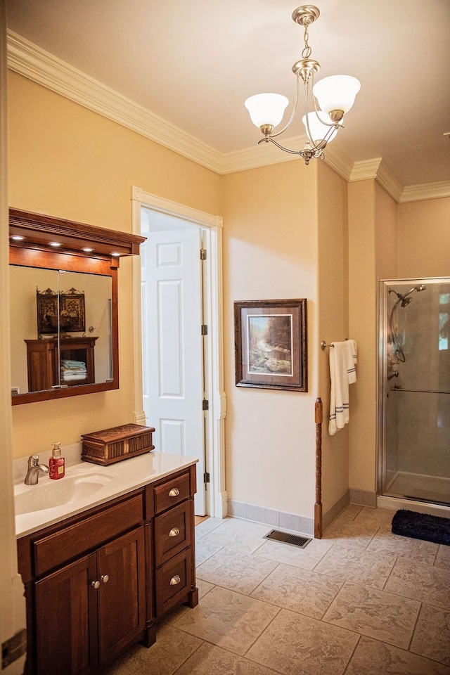 bathroom with tile flooring, an inviting chandelier, a shower with shower door, ornamental molding, and vanity