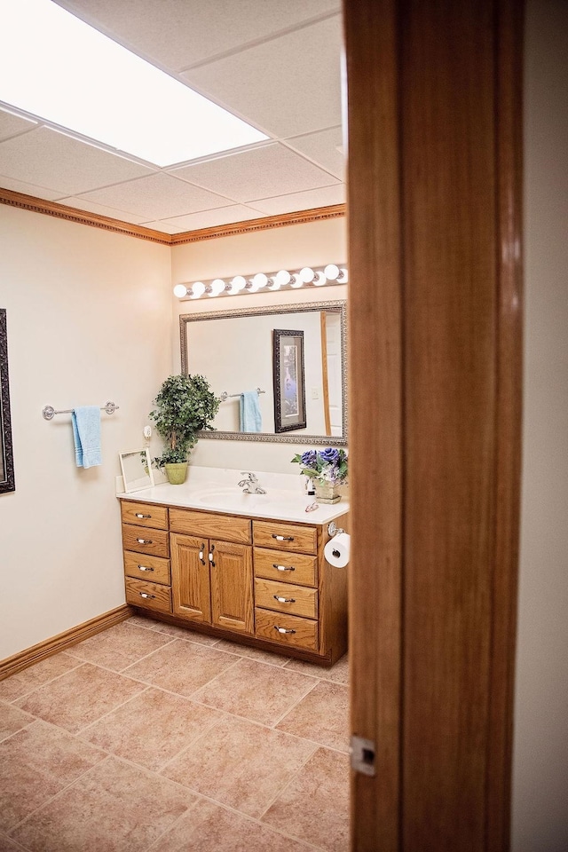 bathroom with a paneled ceiling, vanity, and tile floors