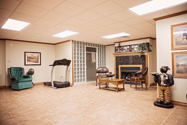 sitting room with tile flooring, a fireplace, and a drop ceiling