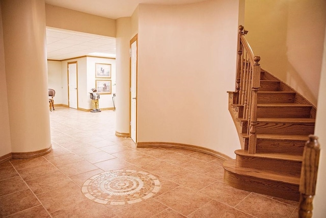 stairway featuring tile floors