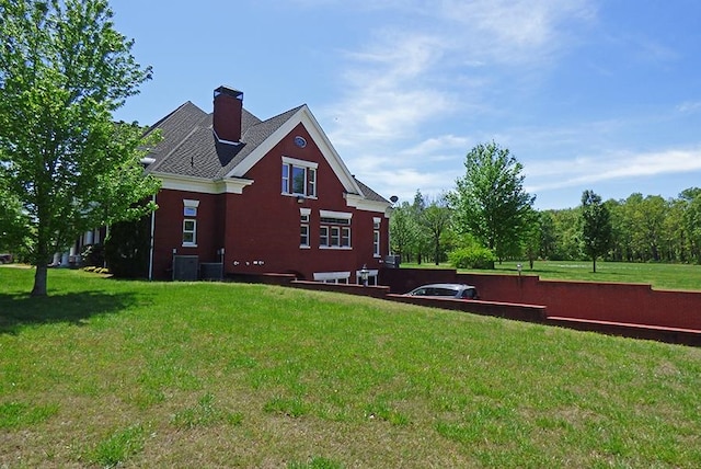 view of property exterior with a lawn and central air condition unit