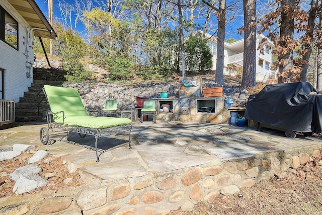 view of patio featuring central AC and grilling area