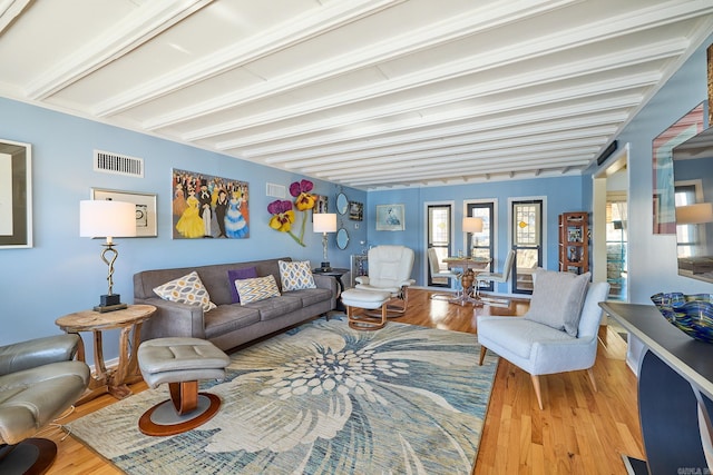 living room featuring wood-type flooring and beam ceiling