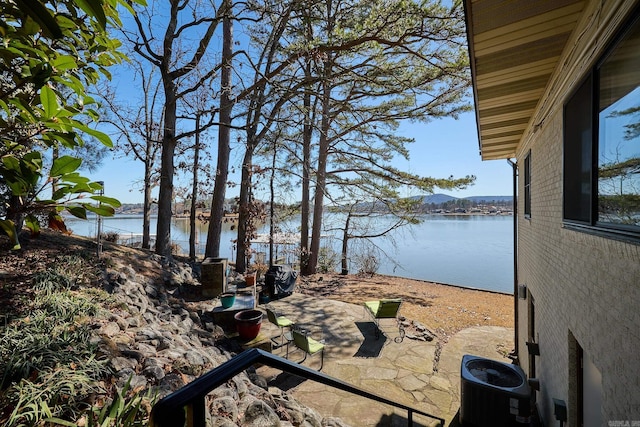 view of yard featuring a water view and a patio