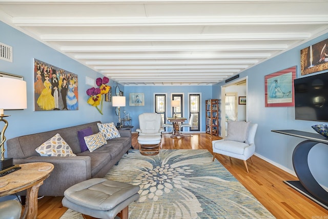 living room featuring hardwood / wood-style floors and beam ceiling