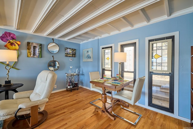 misc room featuring beam ceiling and light hardwood / wood-style floors