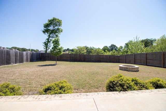 view of yard with an outdoor fire pit