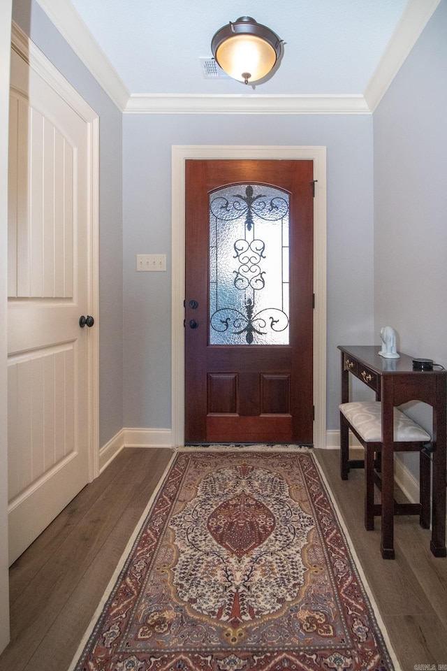 entrance foyer with ornamental molding and dark hardwood / wood-style flooring