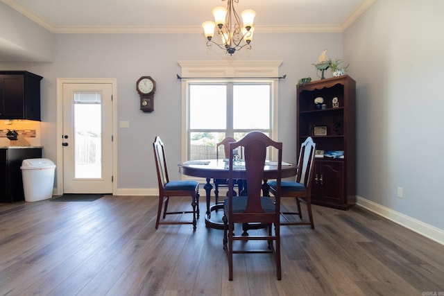 dining room with an inviting chandelier, crown molding, and dark hardwood / wood-style flooring