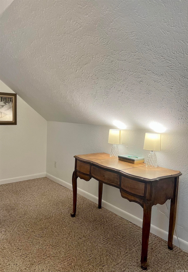 unfurnished office with dark carpet and a textured ceiling