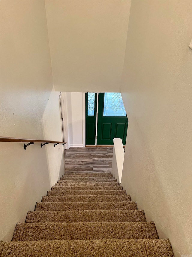 stairs with wood-type flooring