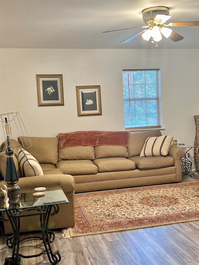 living room featuring wood-type flooring and ceiling fan