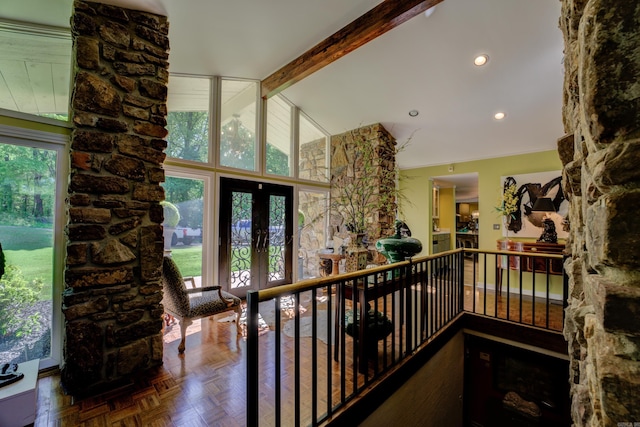 hall featuring french doors, plenty of natural light, vaulted ceiling with beams, and parquet floors