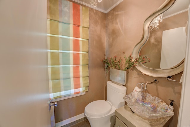 bathroom featuring ornamental molding, vanity, and toilet