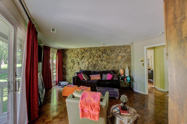 living room featuring a textured ceiling, dark parquet flooring, and crown molding