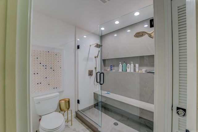 bathroom featuring a shower with shower door, toilet, and tile floors