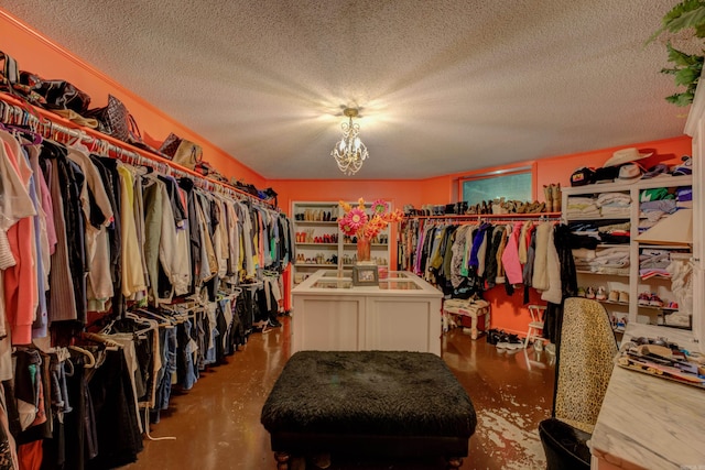 spacious closet featuring a notable chandelier