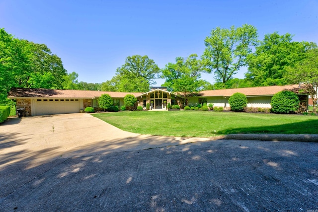 single story home with a garage and a front yard