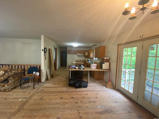 kitchen featuring kitchen peninsula, light hardwood / wood-style flooring, a breakfast bar, and plenty of natural light