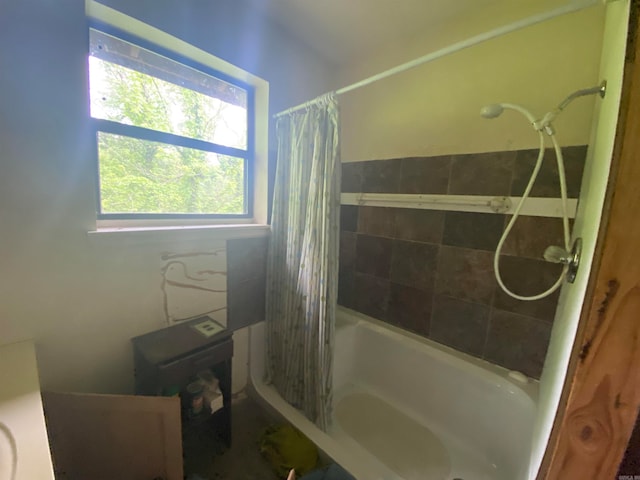 bathroom featuring shower / tub combo with curtain