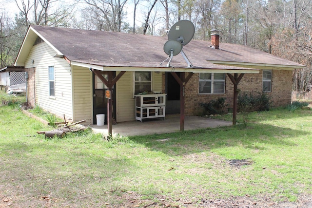 back of property featuring a yard and a patio