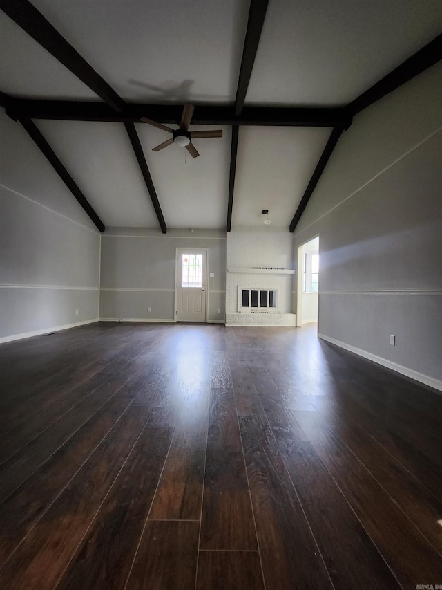 unfurnished living room with lofted ceiling with beams, ceiling fan, and dark wood-type flooring