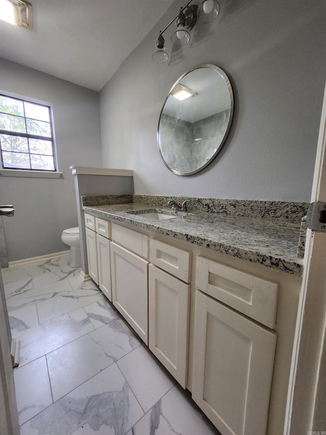 bathroom with toilet, tile floors, and vanity