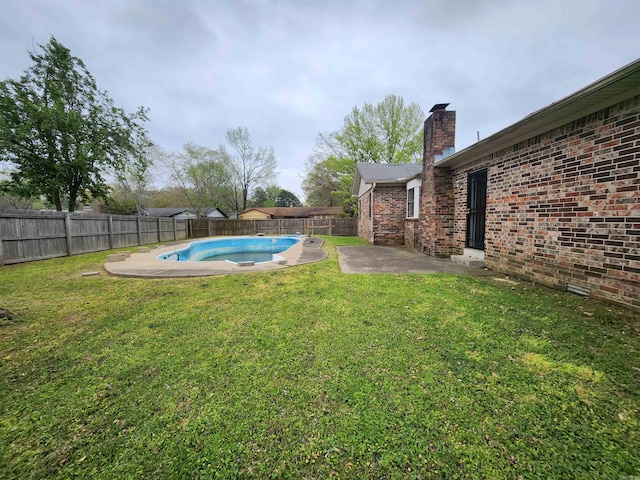 view of yard featuring a patio and a fenced in pool