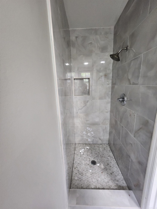 bathroom with a tile shower