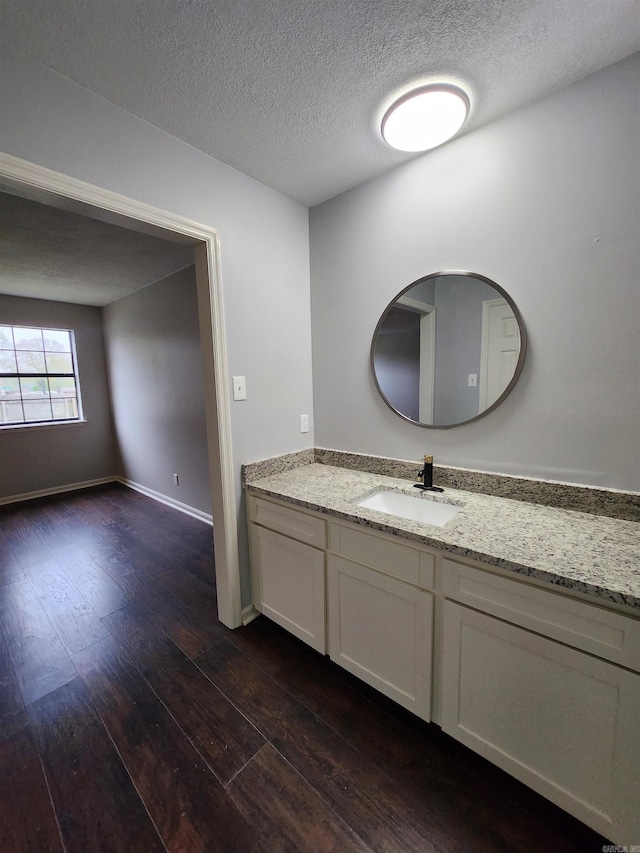 bathroom featuring hardwood / wood-style flooring, a textured ceiling, and large vanity