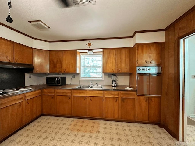 kitchen with sink, stainless steel appliances, crown molding, and light tile floors