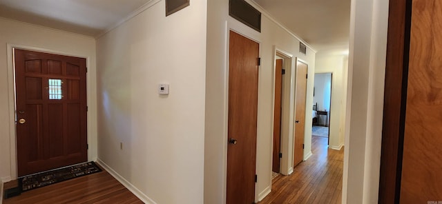 entryway featuring hardwood / wood-style flooring and crown molding