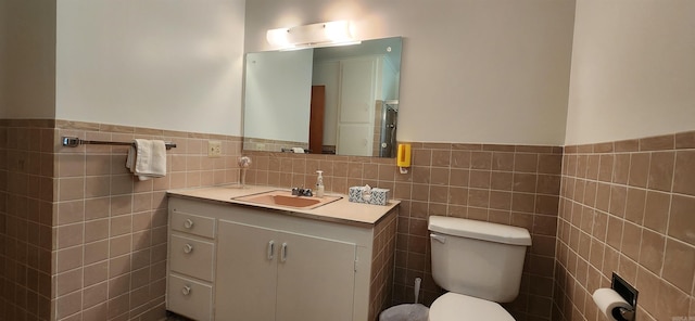 bathroom featuring tile walls, oversized vanity, tasteful backsplash, and toilet