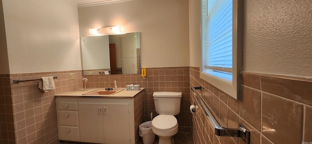 bathroom featuring backsplash, vanity, toilet, and tile walls