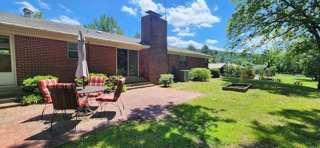 view of yard featuring a patio area and central AC