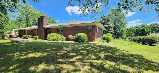 view of side of home with a lawn