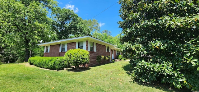 view of side of home featuring a lawn