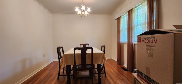 dining room featuring dark wood-type flooring, crown molding, and a chandelier