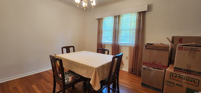 dining room featuring a notable chandelier, crown molding, and hardwood / wood-style flooring